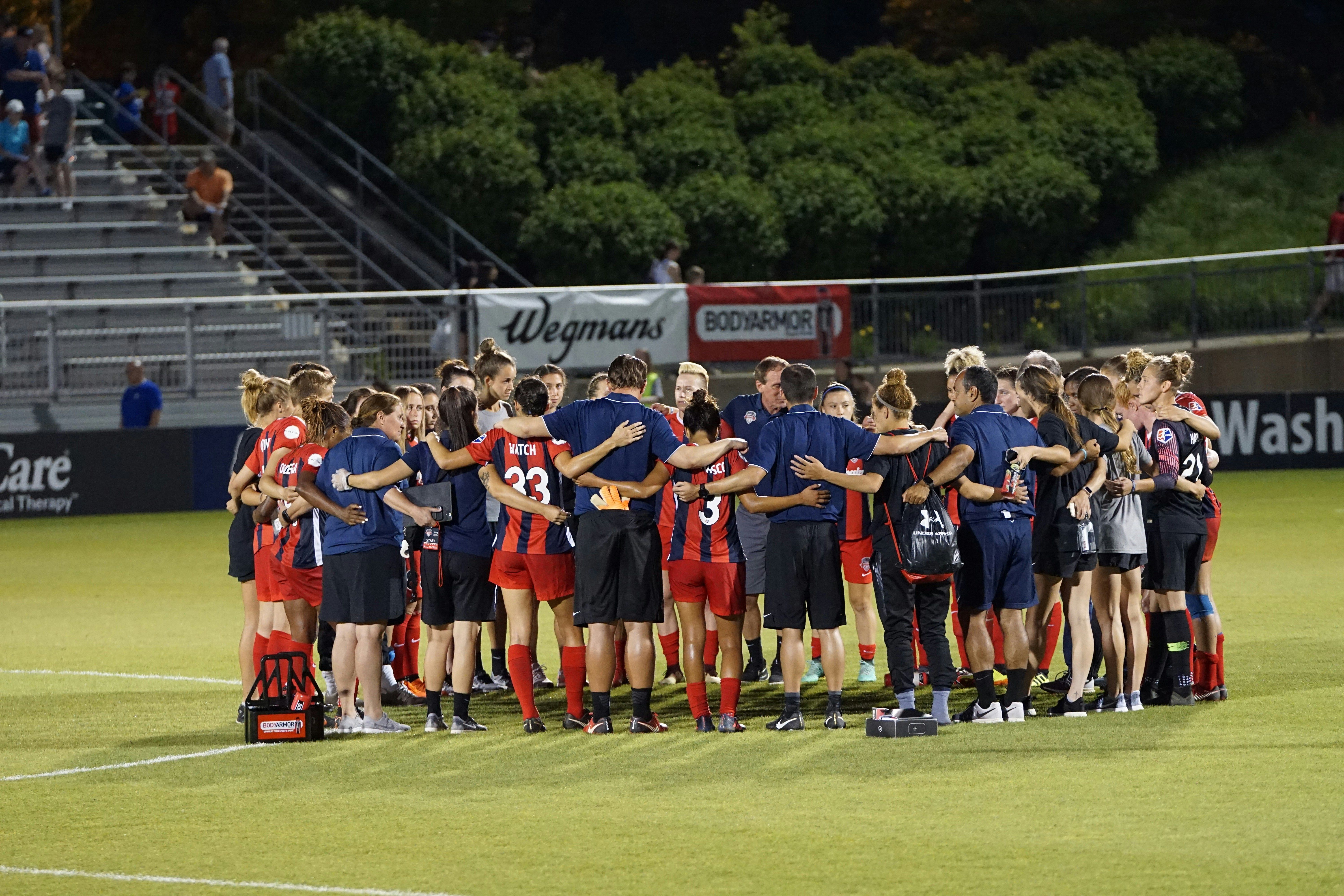 Two soccer teams on green field