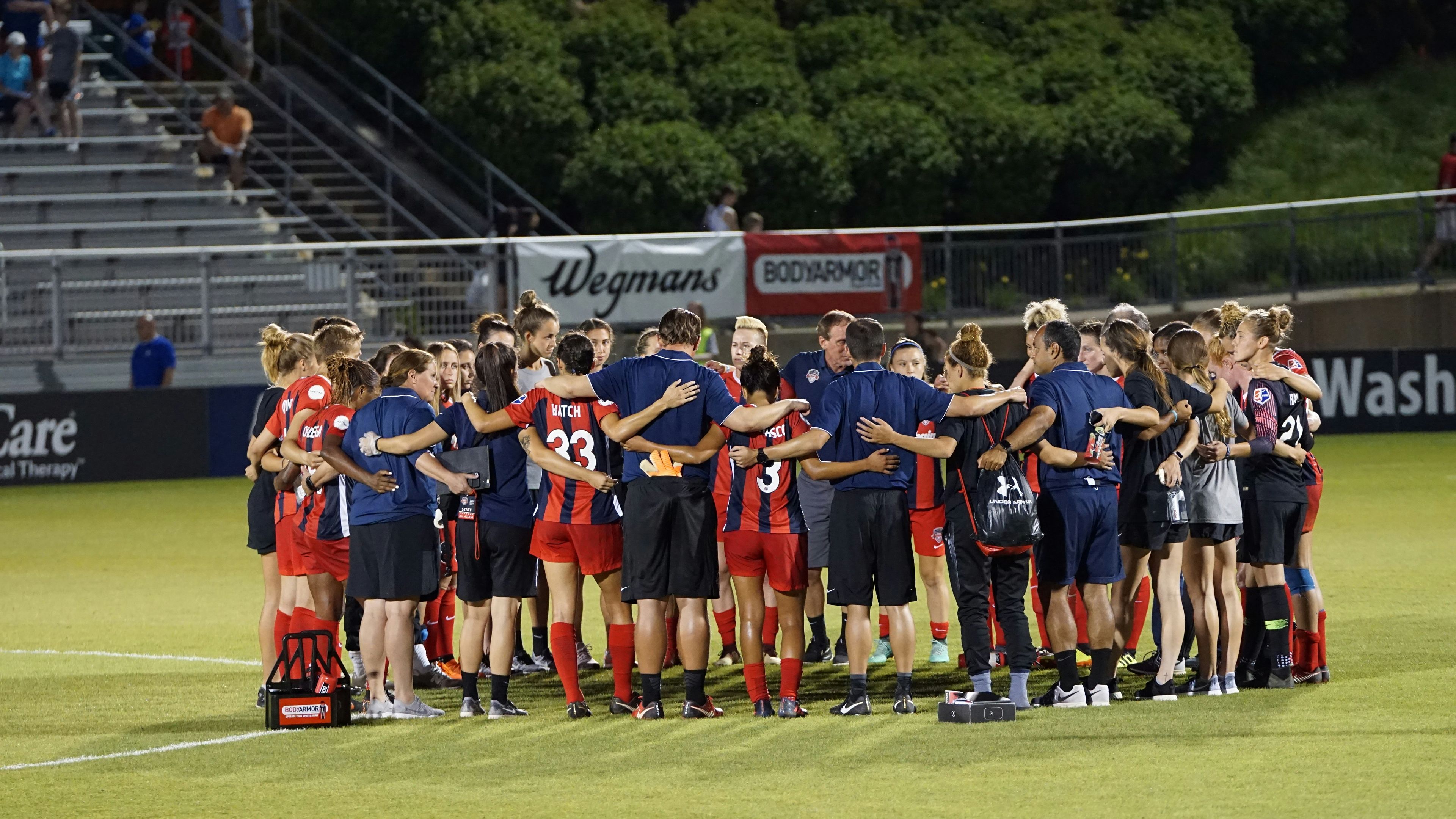 Two soccer teams on green field