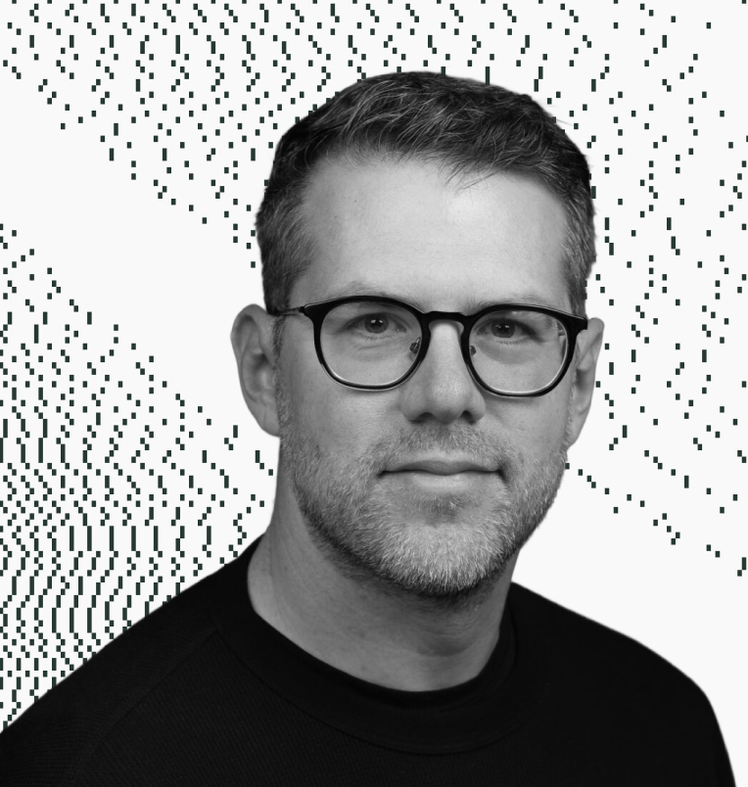 Darrell Etherington wearing glasses and a black shirt looks at the camera
