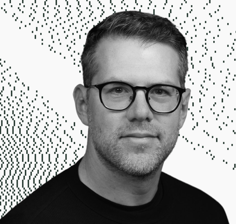 Darrell Etherington wearing glasses and a black shirt looks at the camera