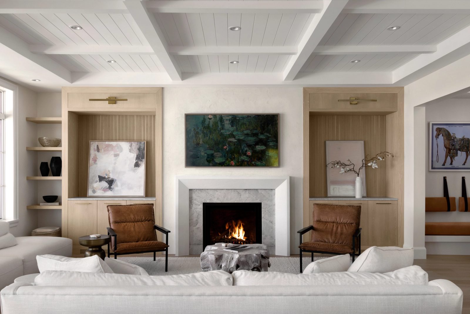 Living room wide — beamed ceiling, plaster fireplace, twin fluted niches