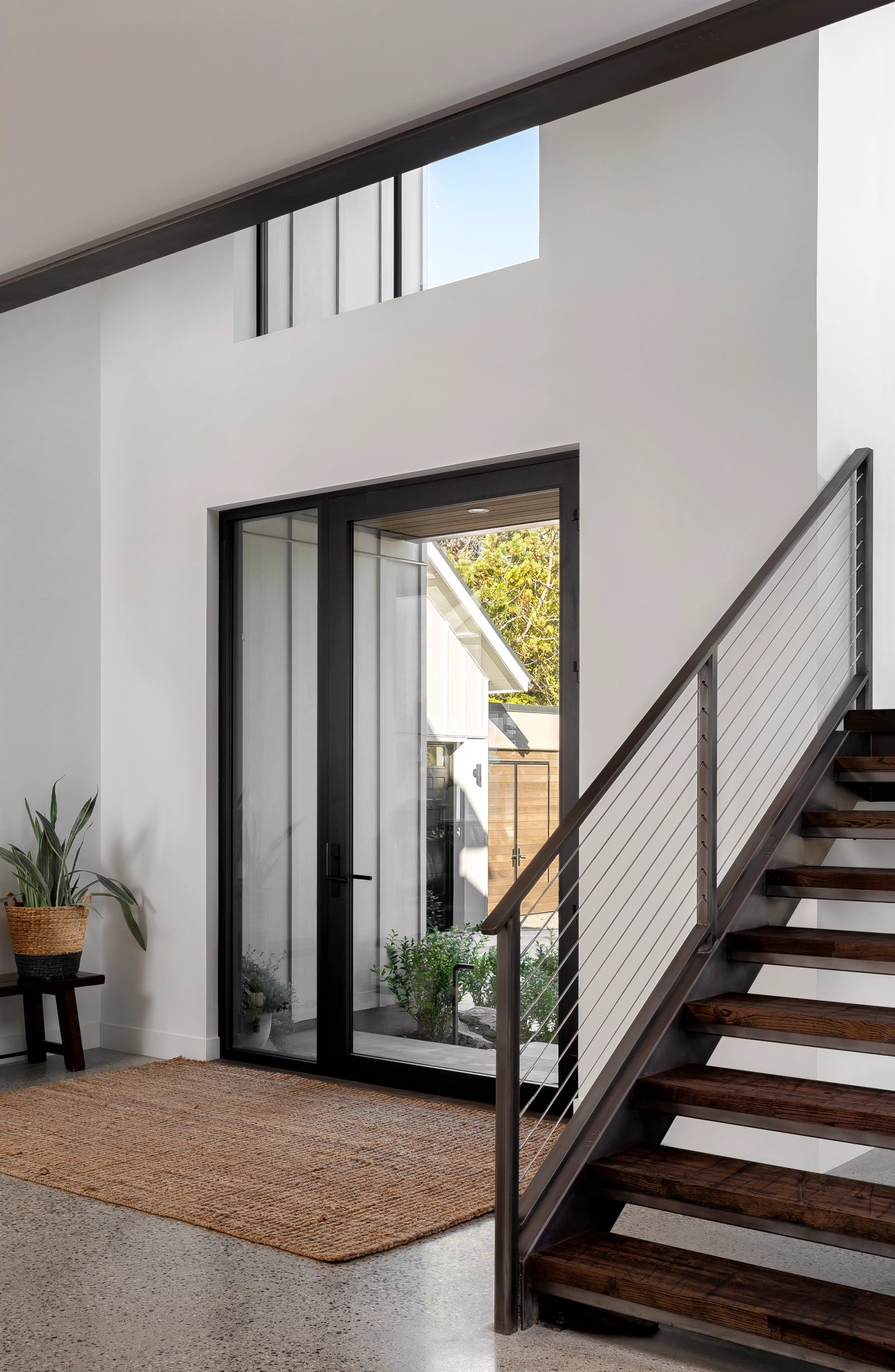 Entry and stairwell — two views of the steel stair