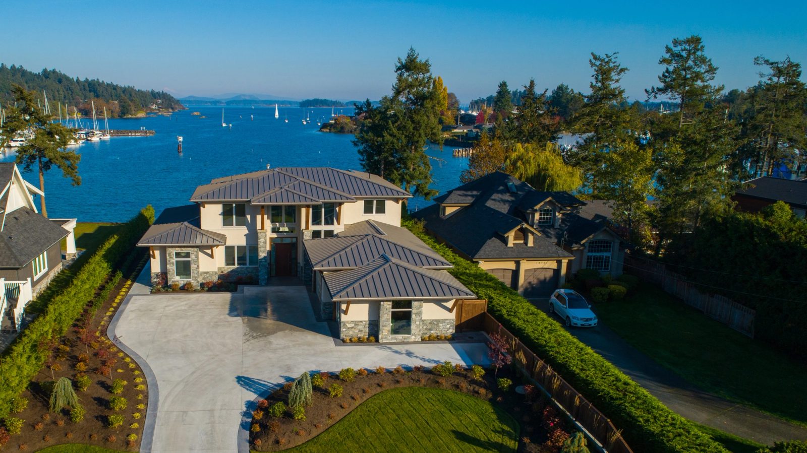 Aerial view over Tsehum Harbour with marinas, moored sailboats and the Gulf Islands beyond