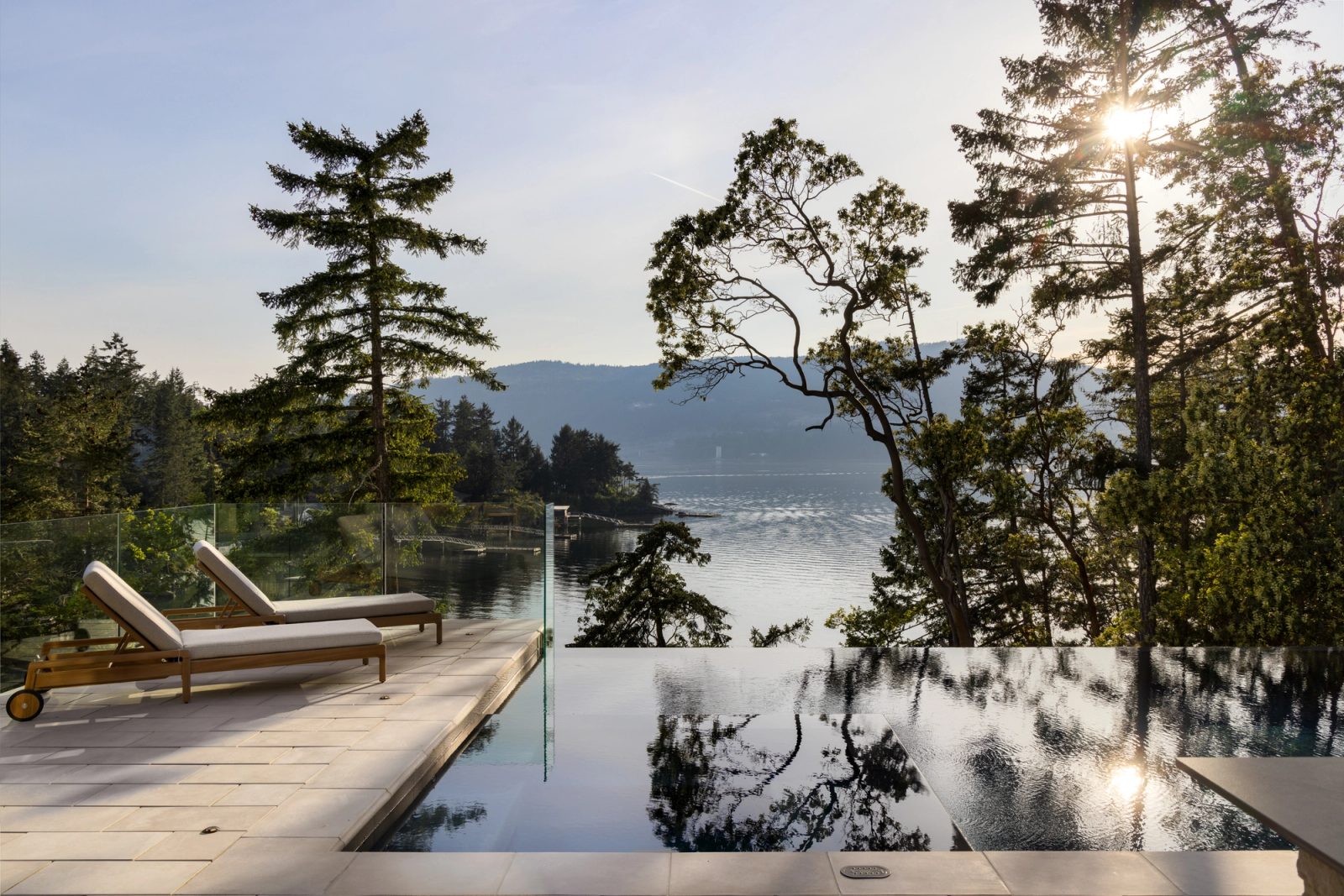 outdoor patio and infinity edge pool with ocean views in the background