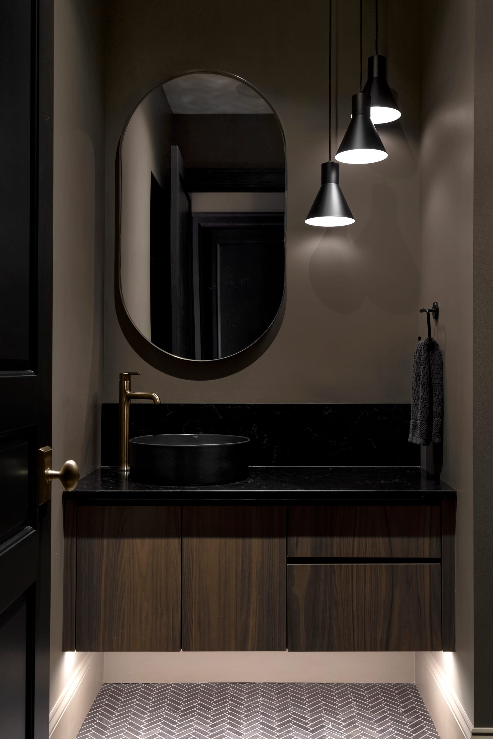 Lower floor walnut and black stone, at room scale and at cabinet scale