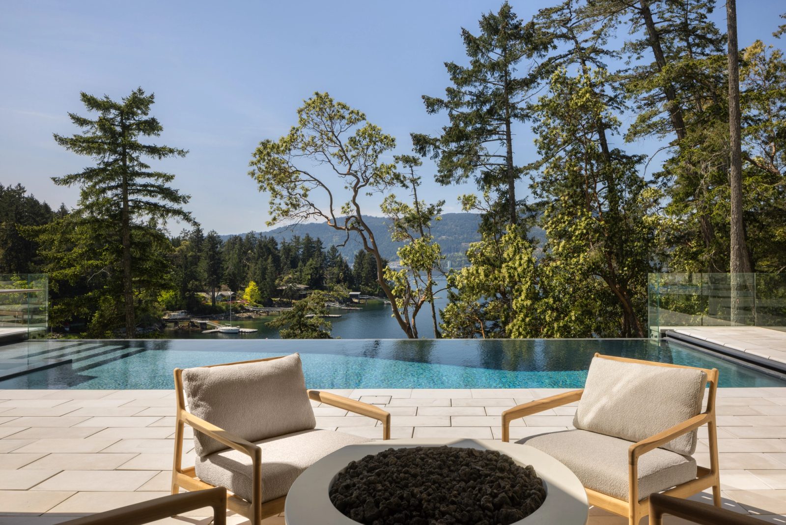 outdoor patio and infinity edge pool with ocean views in the background