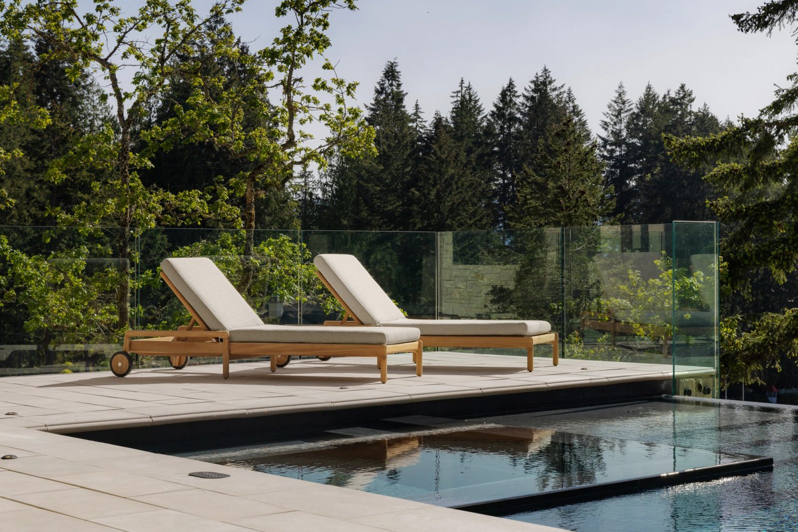 outdoor patio with lounge chairs by the pool