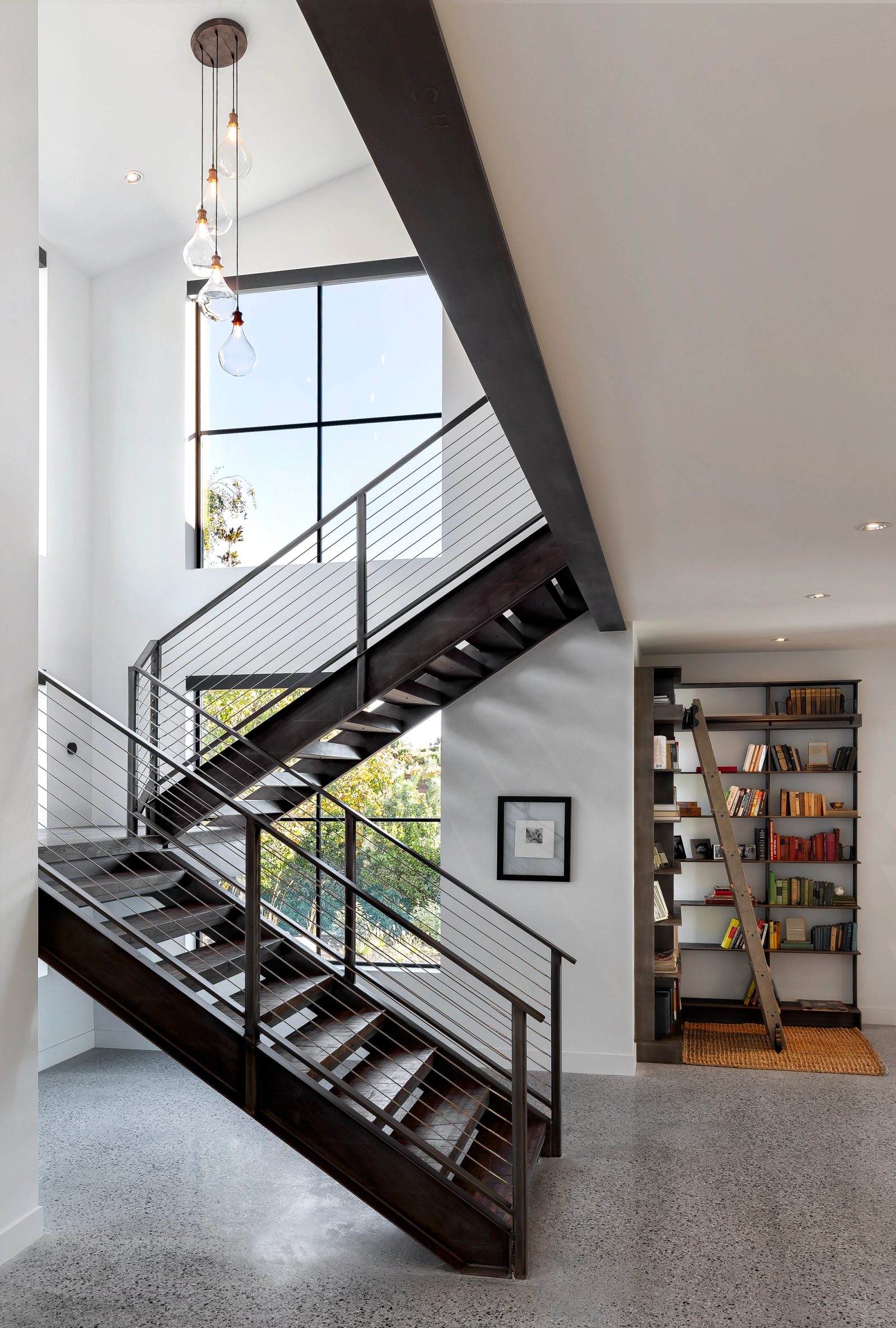 Entry and stairwell — two views of the steel stair