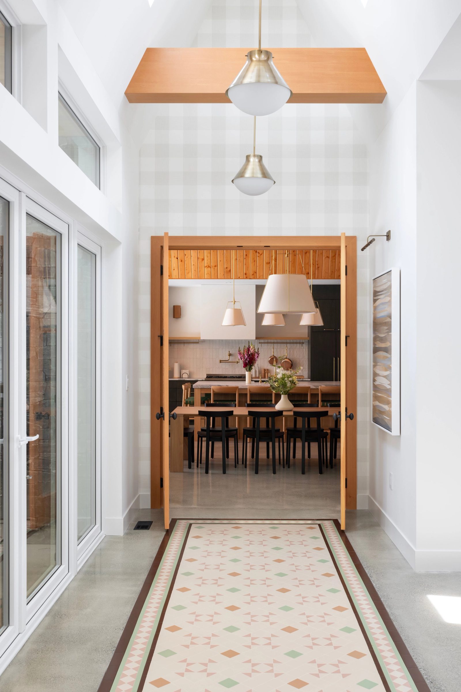 Hall with an inlaid tile runner leading through fir doors to the kitchen