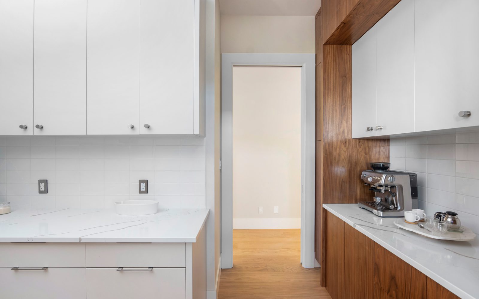Butler pantry with white uppers, walnut lowers and an espresso station