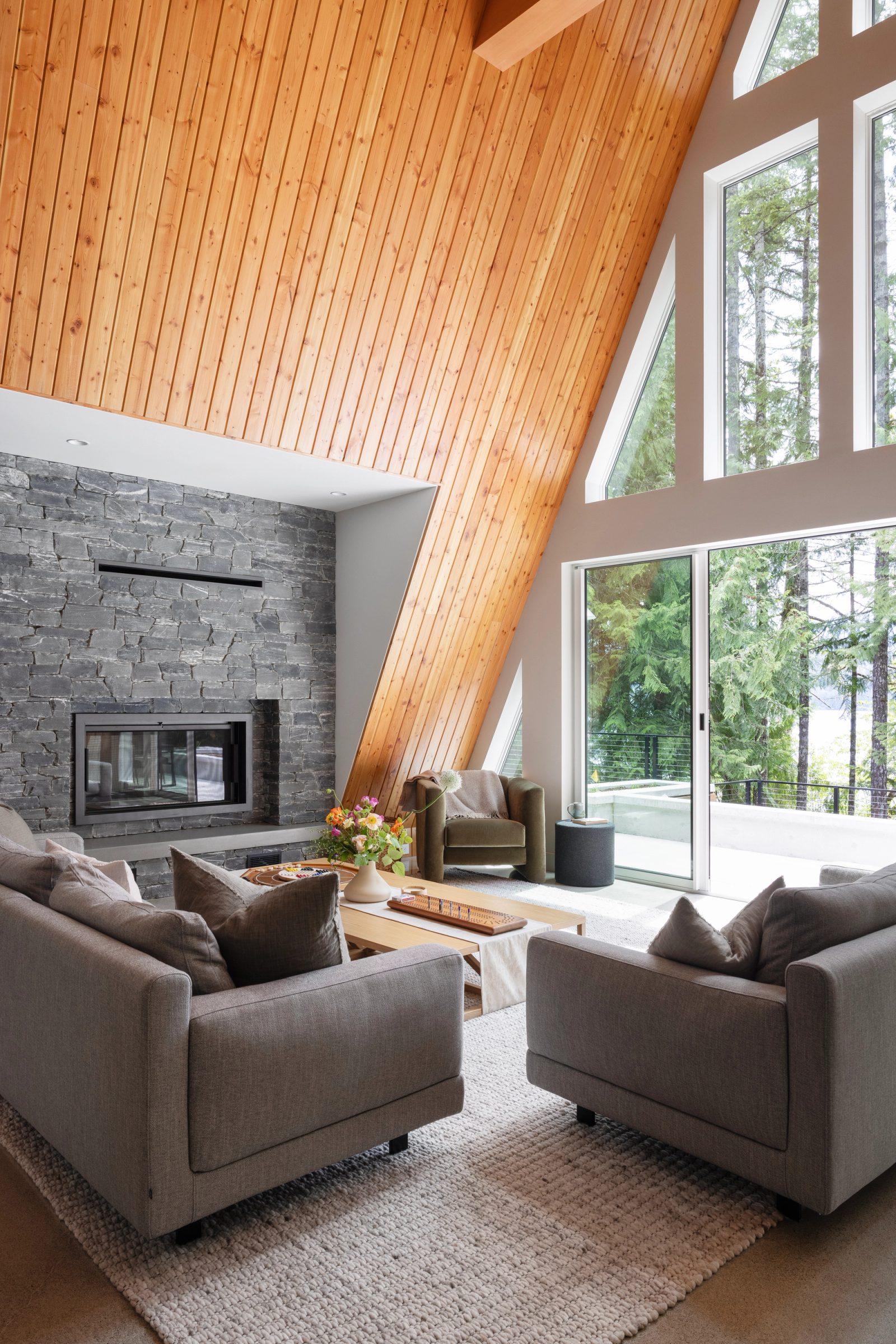 Seating grouped on polished concrete beneath a cedar-lined A-frame slope
