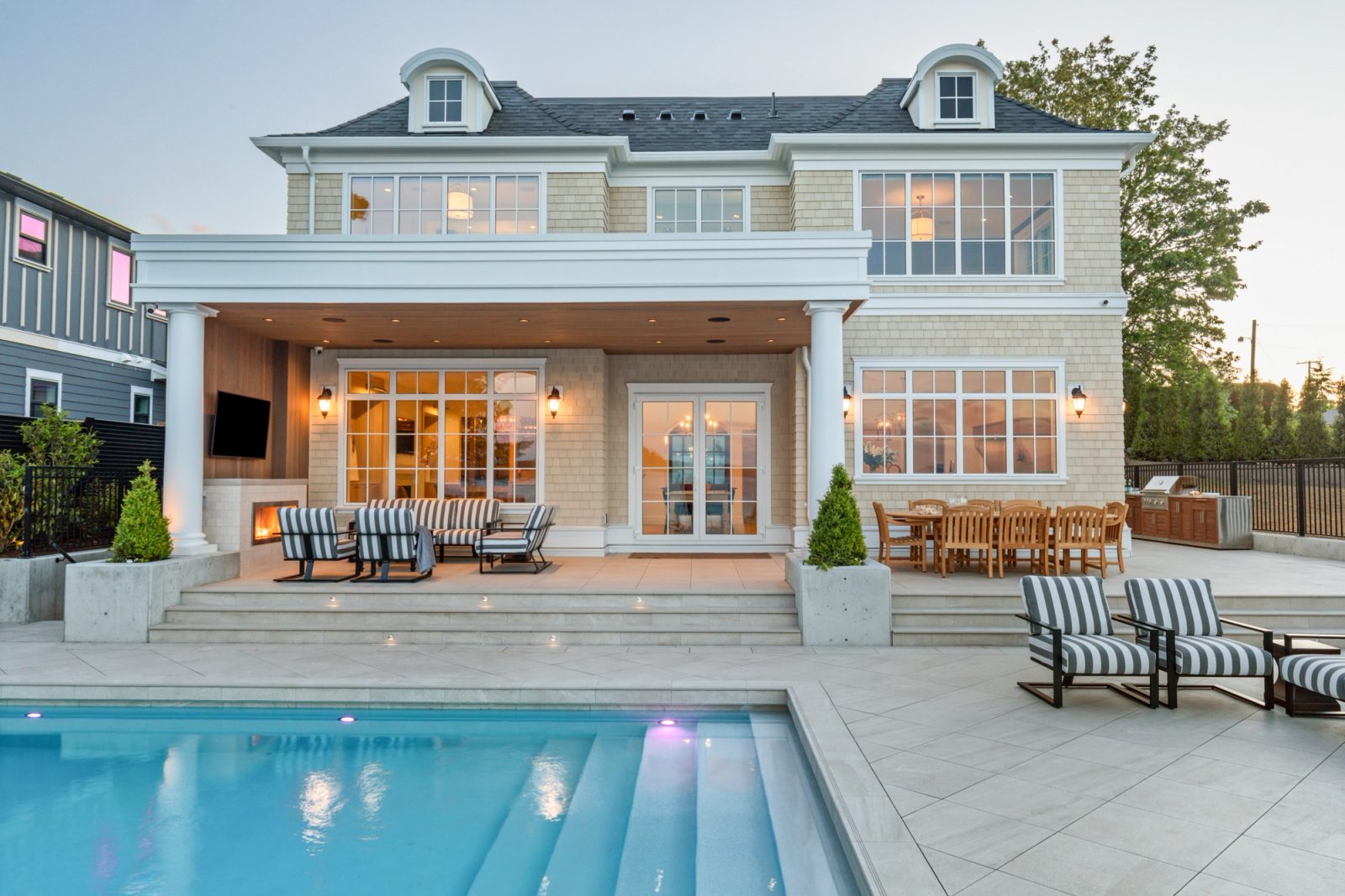 	Water elevation — pool, loggia, terrace, same dusk light as plate 1