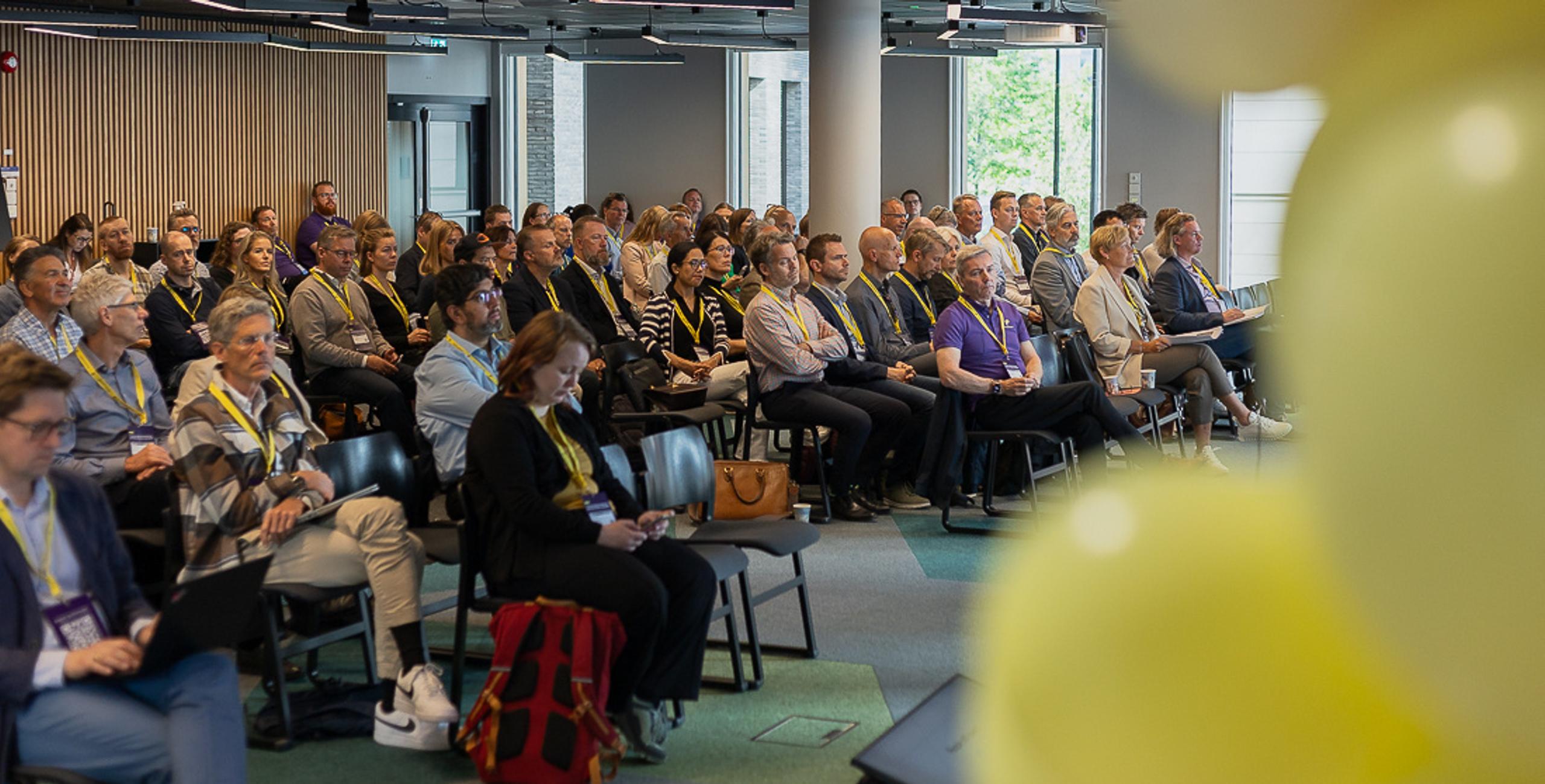 Generisk bilde fra seminar. Publikum og Puzzlepart som sitter og følger med på seminaret.