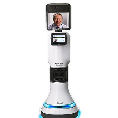 A telepresence robot with blue glowing lights on the wheeled base , a thick trunk with a touchscreen and electronics, and a large display on top which shows a doctor's face.