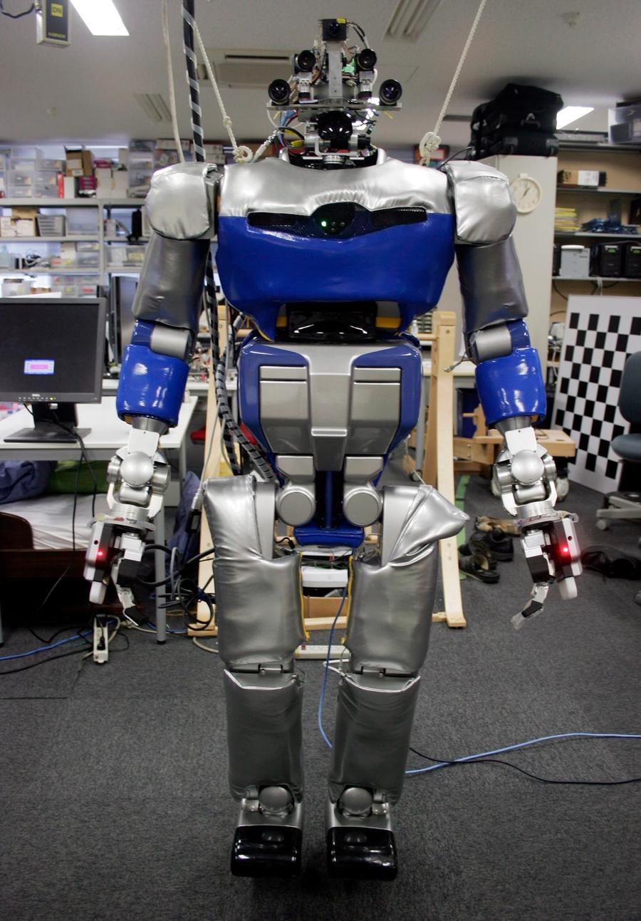 A different view of the robot shows an uncovered head with many cameras.