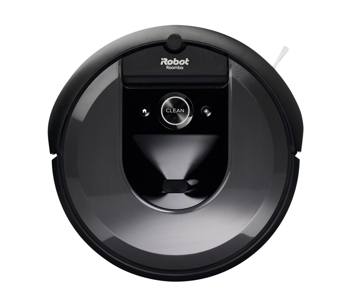 Rotating view of a dark gray, squat, round robotic vacuum stood up on its end. It's bottom view shows its brushes and cleaning system.