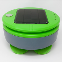 A round green robot with green pad feet and a silver middle and a solar panel on top.