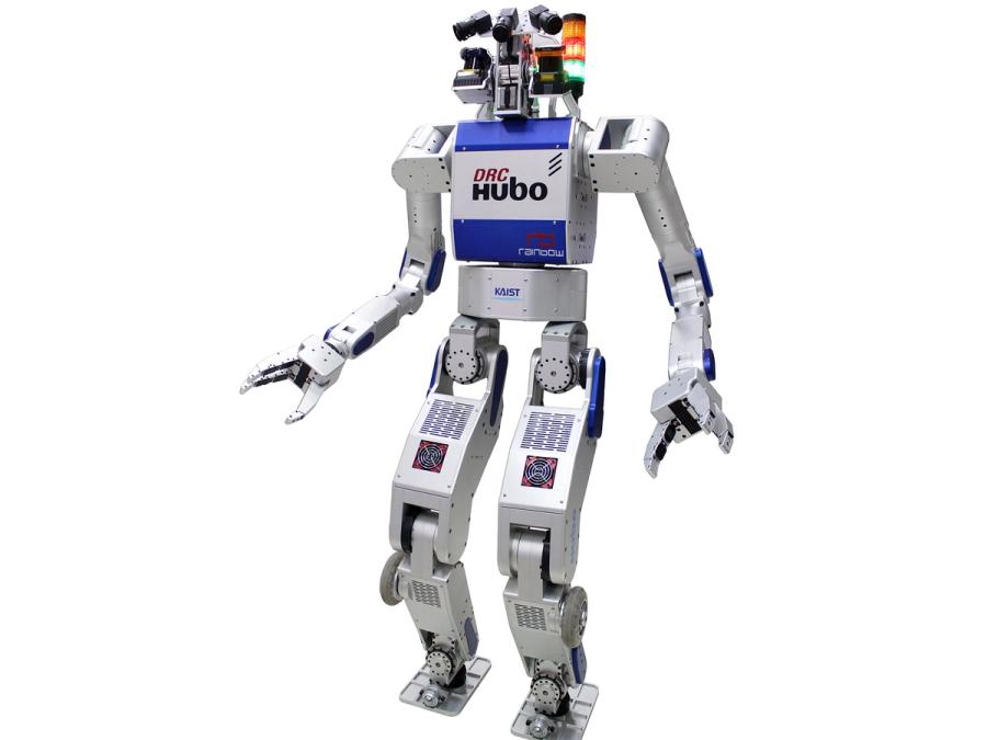 A 1.45 meter tall bipedal humanoid robot with a silver body, gripper hands and cameras and sensors in its head.