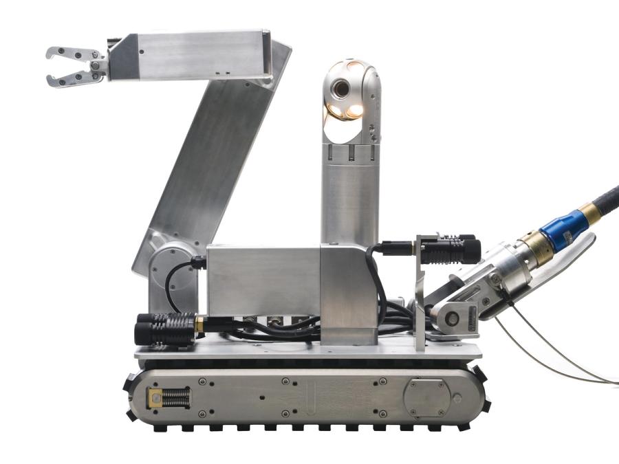 A mobile robot with a base that is a tracked wheel, supporting metallic extensions including an arm with a gripper attachment, and a vertical column with a camera.