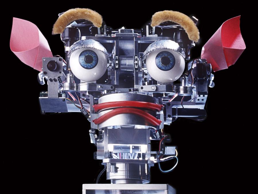 Close-up of the robot's face. It's lips and eyes are contorted in a way that mimics fear or shock.