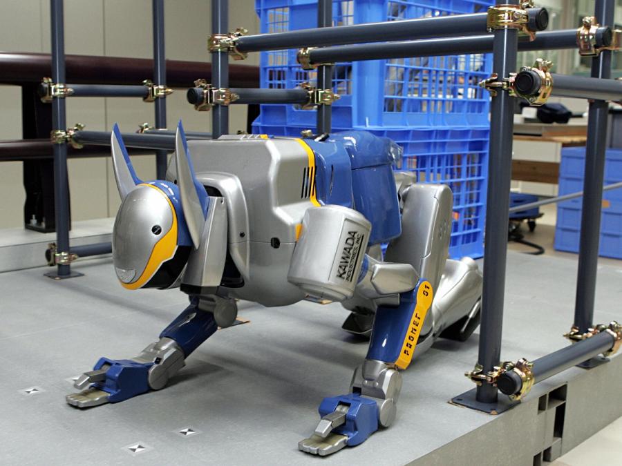 The bipedal robot is positioned on all fours so it can go under a horizontal bar. Two pointed pieces which look like overly large cat ears protrude from it's head.