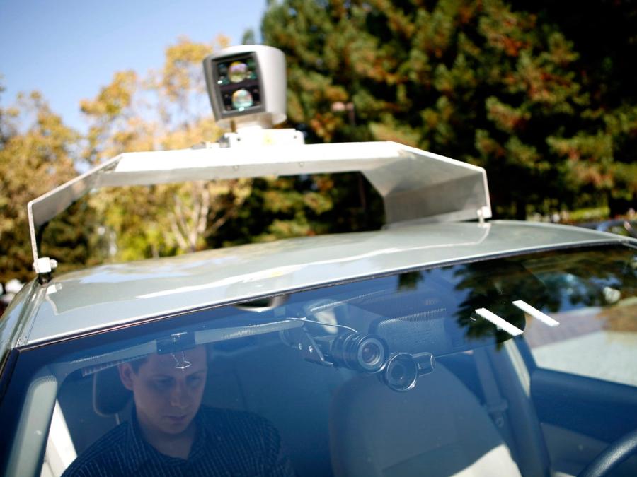 A close-up view shows cameras behind the windshield as well as the lidar on top of the car.