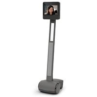 A wheeled telepresence robot with a display on top that shows a smiling woman.
