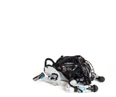 An advanced humanoid robot lies face down, then gets up into a standing position.