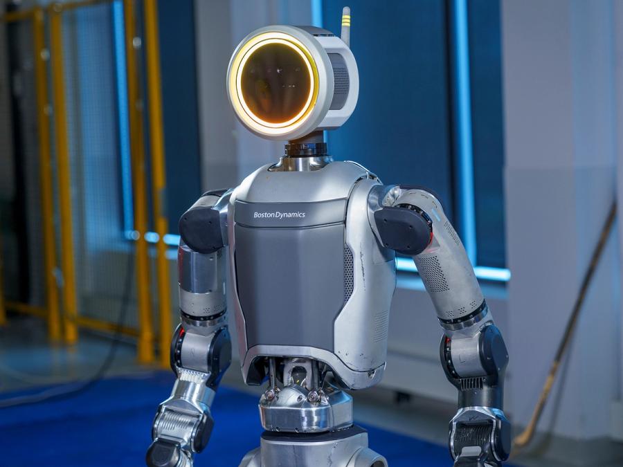 A waist up view of the robot highlighting its circular face, which glows yellow.
