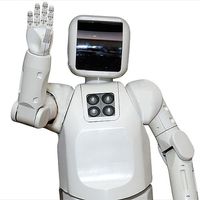 A white robot with a black face plate waves at the camera.