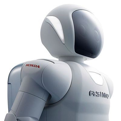 Close up of Asimo, a white robot with a face shield and backpack.
