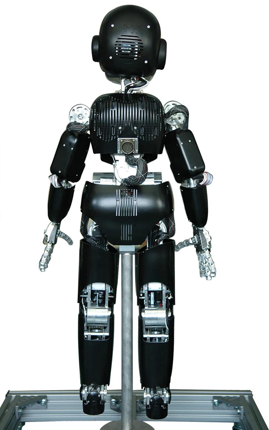 Rear view of the black and silver child-like humanoid robot.