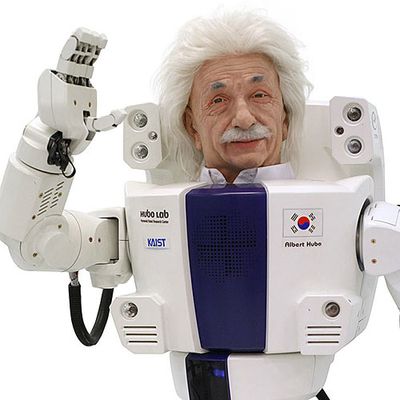 A male humanoid robot with fluffy white hair and a mustache in the style of Albert Einstein waves.