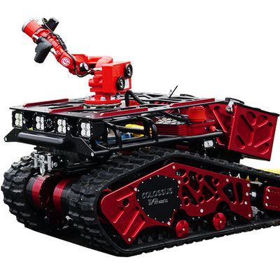 A large red robotic vehicle with tracks and an articulated arm.