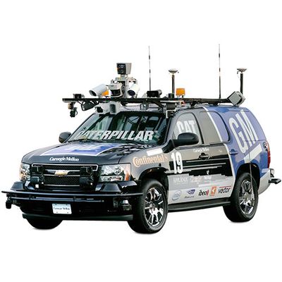 An SUV mounted with cameras and tech on top, and covered in logos.