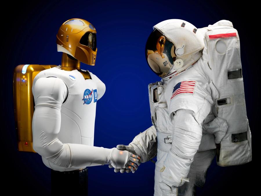 Robonaut shakes hands with an astronaut.