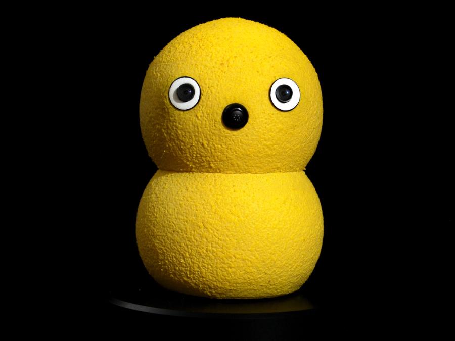 A robot that looks like two yellow balls squished together, with googly eyes and a button nose.