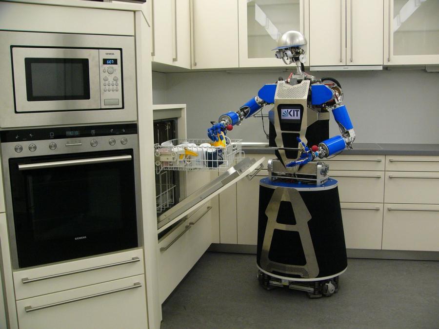 A two armed robot with a wheeled base manipulates dishes in a dishwasher.