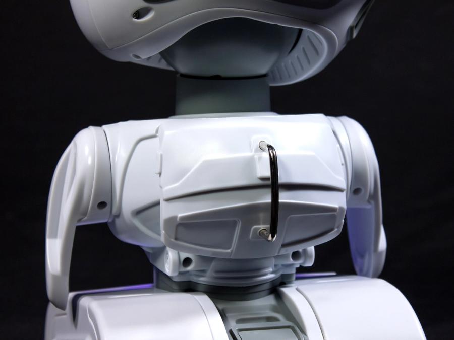 Close-up of the back of the robot shows a small backpack with a vertical black handle.