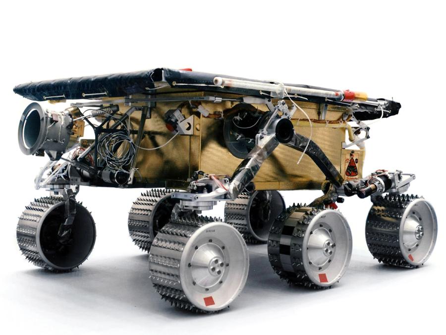 An older rover with six legs, a boxy beige base, and cameras and electronics.