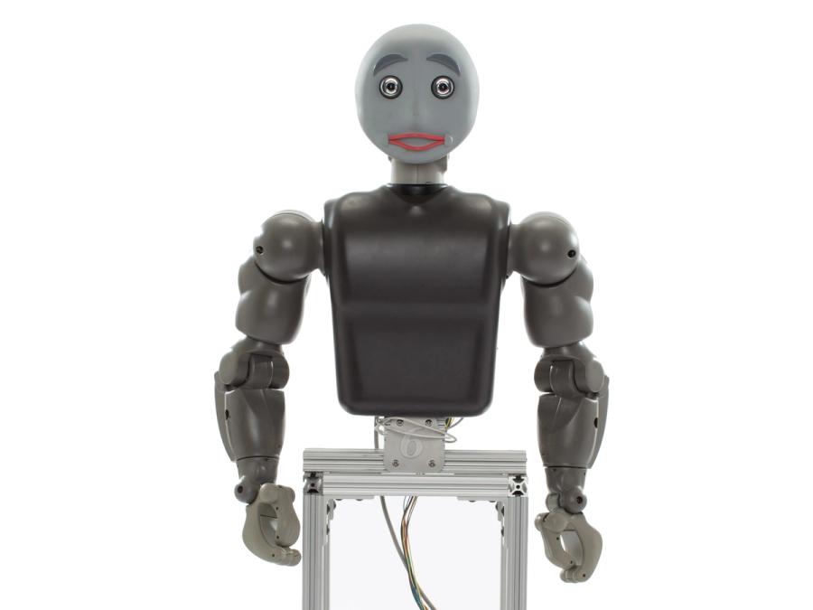 A robot with a torso, two arms with gripper hands, and a smiling face, attached to a frame base.