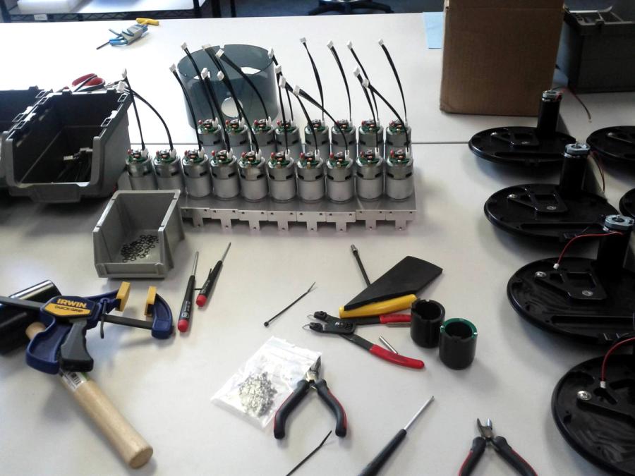 Tools and electronic components on a table.