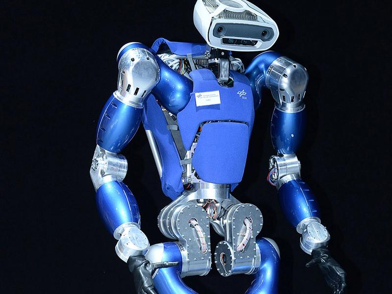 A shiny blue and silver bipedal humanoid with powerful arms, black hands, and a cute rounded rectangular face with cameras and sensors, and two jointed legs.