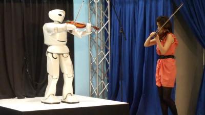 Partner plays the violin with human musicians.