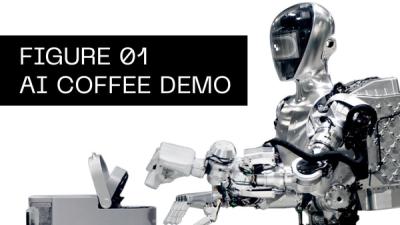 The silver humanoid robot Figure uses a Keurig coffee machine to make an employee coffee.