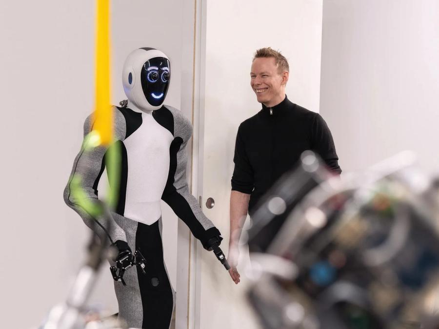 A humanoid robot smiles at a human.