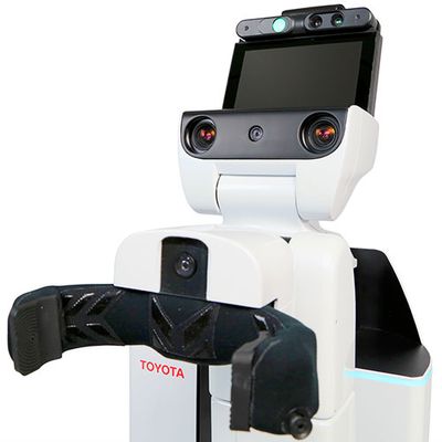 A black and white robot with a black claw-like gripper on its torso, and a head composed of camera eyes and a tablet display.