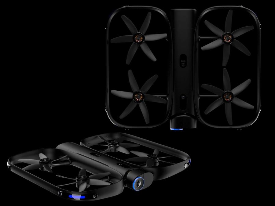 Two views of a black drone with two rectangular side by side sections housing four rotors total, as well as having many cameras.