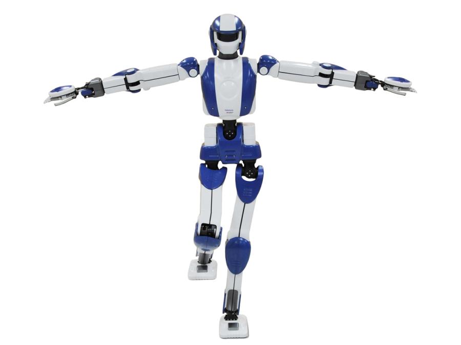 The blue and white humanoid robot is balanced on one foot, and has both it's arms spread out to the sides.