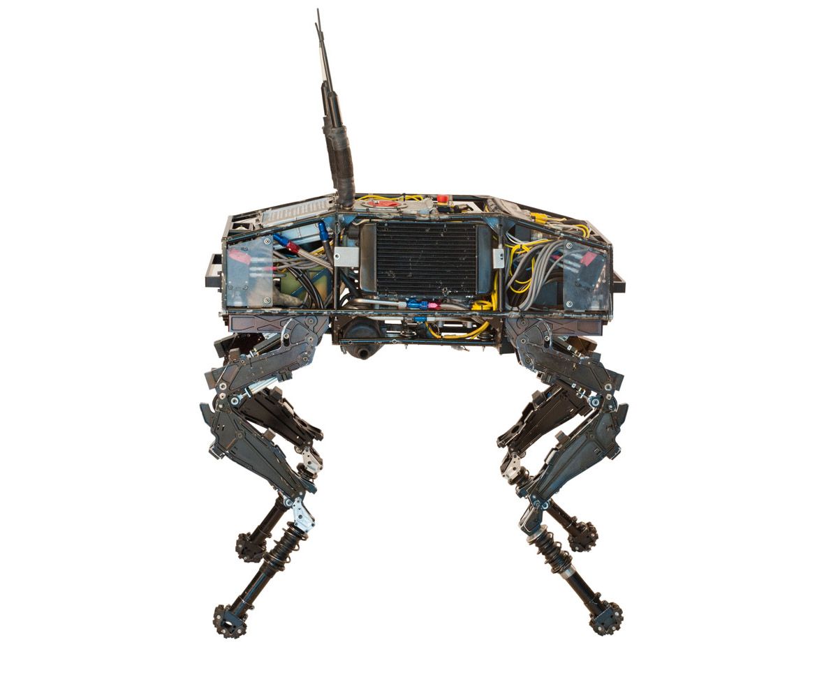 A series of images spin a quadruped, dog-like robot with its electronics exposed.